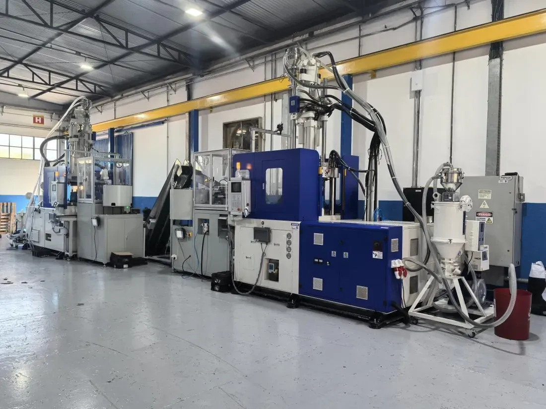 Machines marked B and D with a conveyor between the first-molding and overmolding positions