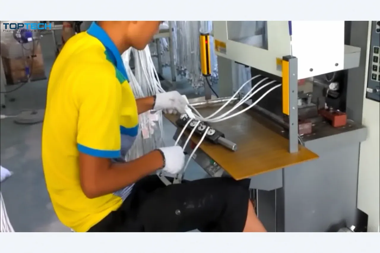 A second block with cable assemblies sits outside the closed mold in the production footage.