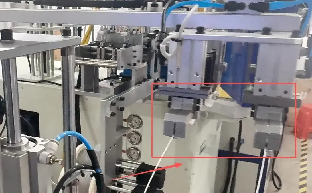 Final robotic grippers in the meter seal line, highlighted by the original red box and arrow